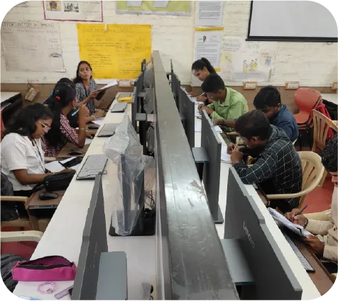 Instructor guiding students in a computer lab during hands-on accounting training